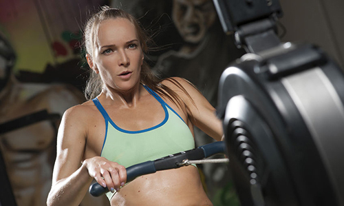 Woman exercising on rowing machine